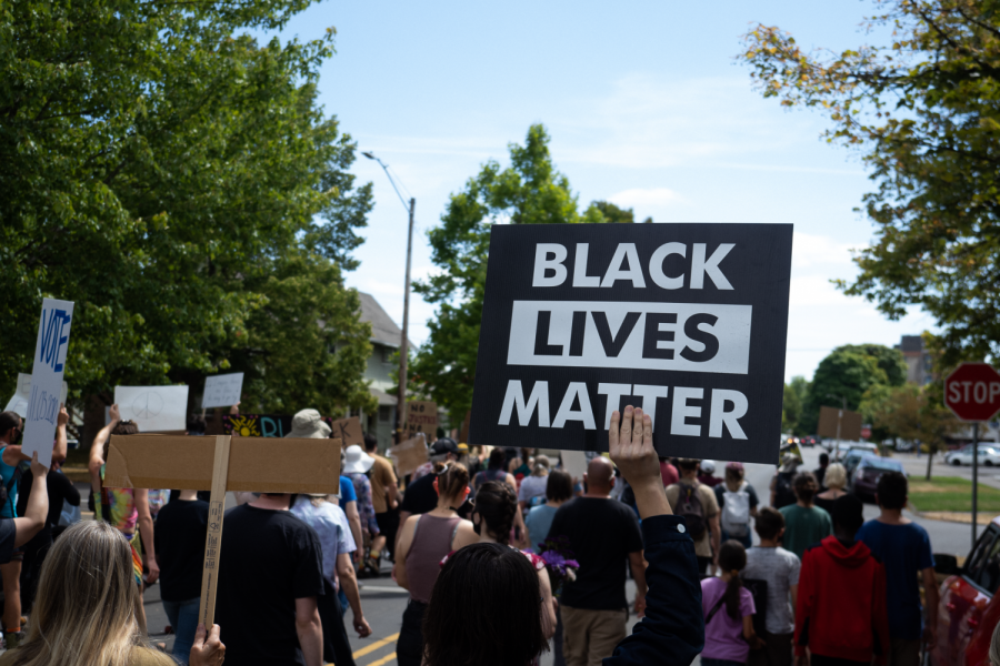 Local residents march through downtown Corvallis, Ore. holding signs in support of the Black Lives Matter movement.