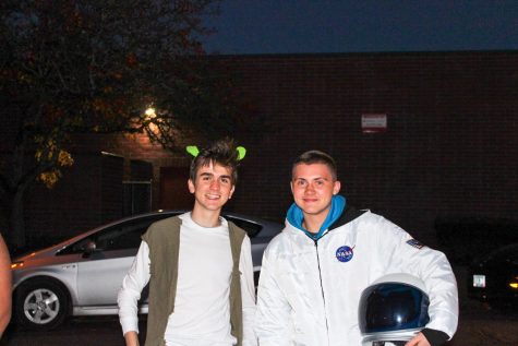 Two students dress up as Shrek and an astronaut