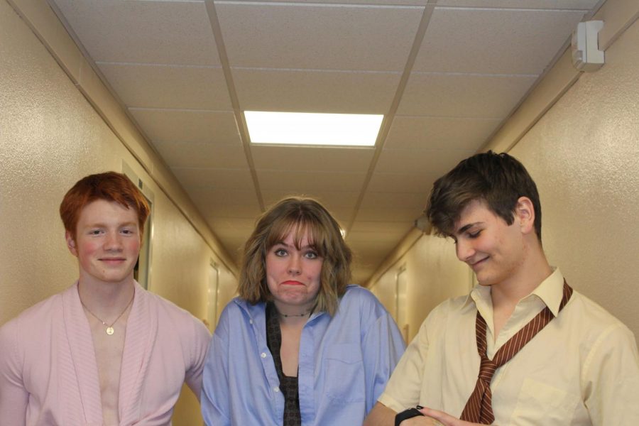 Three OSU students stand in the hallway of their dorm building dressed as Jim, Pam and Dwight from The Office.