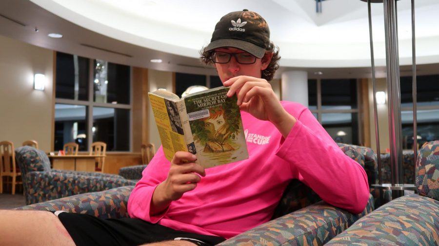 Freshman Ben Stier pictured reading “The Secret of Mirror Bay” the 49th volume in the “Nancy Drew” mystery series. Published in 1972 under the false moniker of Carolyn Keene, this installment sees the protagonist of the series, Nancy Drew solve the mystery of a woman seen gliding over the water in Mirror Bay.