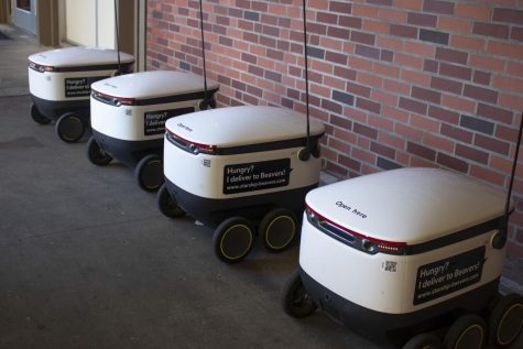 4 delivery robots against wall