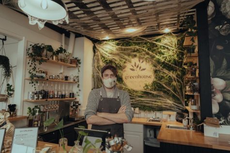 Owner of Greenhouse Coffee and Plants Bryon Daniels standing with arms folded