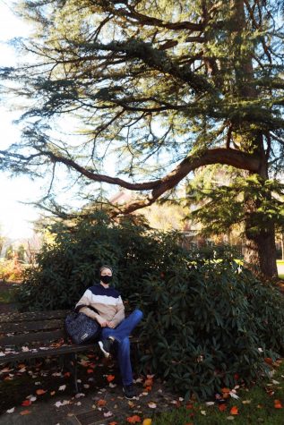 Michael McArdle sits on a bench under a tree on the OSU Corvallis campus.