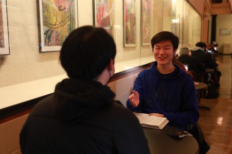Noah Tjandra chats with a friend in the Memorial Union building on the OSU Corvallis campus.
