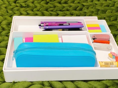 Various office items arranged on a desk organizer