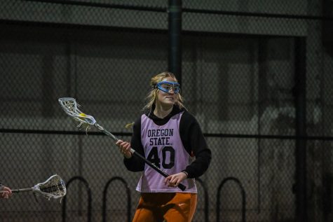Play #40 prepares to catch the ball during an OSU Women's Lacrosse night practice.