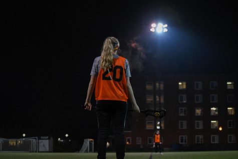 Play #20 stands in the intramural field at night, with the stadium lights overhead.