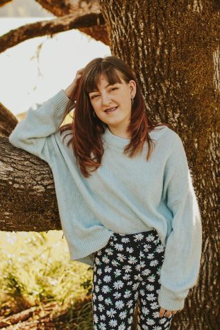 Emma Simon leans up against a tree