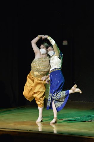 Kytan Van, left, and Christina Nguyen stand together on stage with their arms together to form a heart.