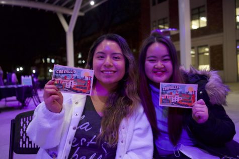 Jessica Garcia (left) and Madeline Judokusumo (right) smile with their postcards.