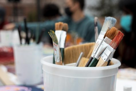 A bucket of paint brushes.