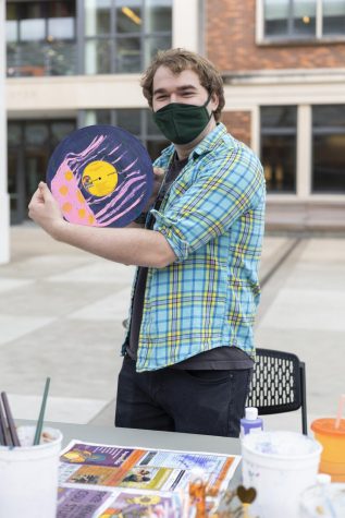 Andrew Foran holds up his record art. His art features a polka dot jellyfish.