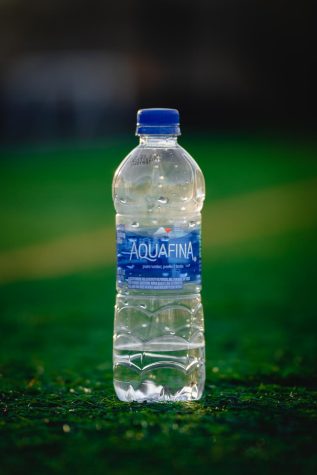 An Aquafina water bottle sits on the turf of the intramural fields on the OSU Corvallis campus.