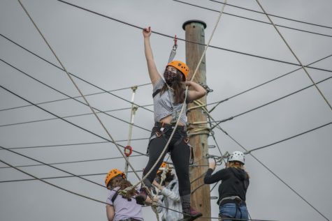 A student makes their way through the challenge course in the air.