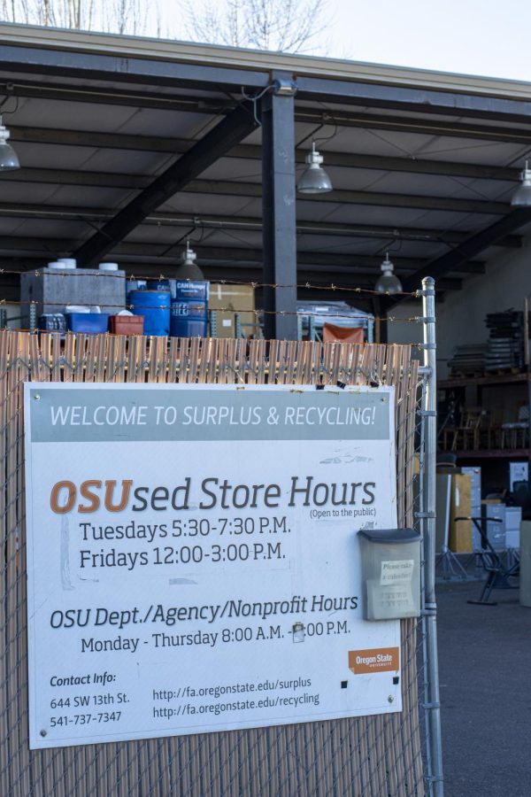 The sign outside of the OSUsed Store shows its hours of operation.