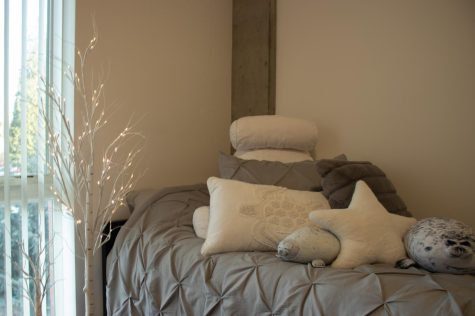 Picture of bed with different shaped pillows