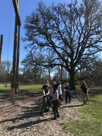A group of people pull on a rope.