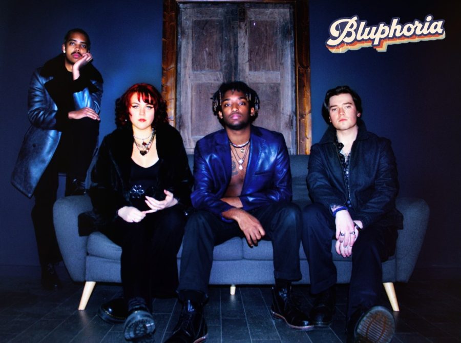 From left to right: Dakota North, Dani Robinette, Reign LaFreniere and Rex Wolf sit on a couch with serious faces. The bands name Bluphoria is written above them.
