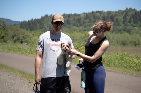 Oregon State seniors and roommates Emerson Chase (left) and Brooklynn Rawski pose for a picture with dog Winston on the Bald Hill trail in Corvallis, Ore. on May 21, 2022. Going on a hike and exploring Corvallis before graduation was something on Rawski’s bucket list that has now been crossed off.