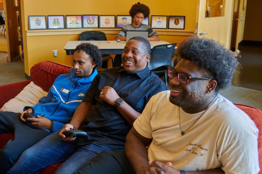 Jamar Bean, the new Center Director at the Black Cultural Center, is pictured playing video games with some of the students who frequent the center on October 7, 2022. Jamal took over as the director in mid-September.