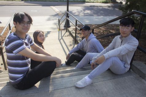 Dylan Luong (he/him, front left), Stanley Lu (he/him, front right), Katelyn Nguyen (she/her, left back), and Eric Kong (he/him, right back) posing for a picture on the front steps of the Asian & Pacific Cultural Center of Oregon State University in Corvallis, Oregon on Oct. 6, 2022. The APCC is a space used for studying, club meetings and  hanging out, open to all students regardless of ethnicity.
