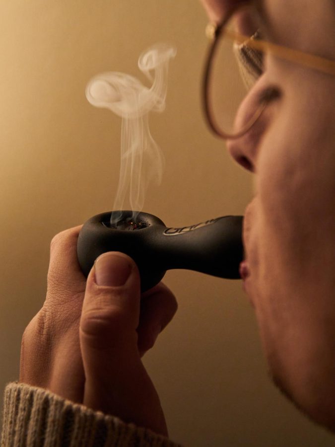 21 year-old OSU sophmore, Cameron Fletcher, tokes from his weed pipe from the comfort of his own home on Dec 9, 2022. Coming from Southern California, Fletcher is no stranger to smoking, eating, or vaping weed. 