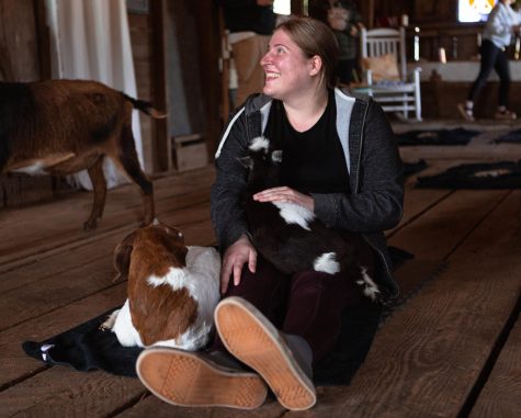 Rebecca Adams with one of the baby goats in their lap on April 30, 2023 at the Original Goat Yoga located in Monroe, Oregon. This is the home to where the viral trend of Goat Yoga began and where goat yoga classes and happy hour still take place.