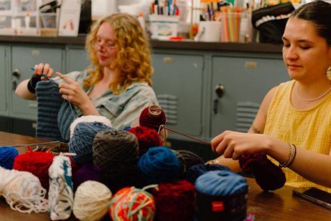Bree Peterson (left; she/her) and Tehani Hussey (right; she/her) working on crochet projects at the Craft Center on May 26. Peterson crocheted a hat while Hussey reorganized yarns for the Crochet Club.