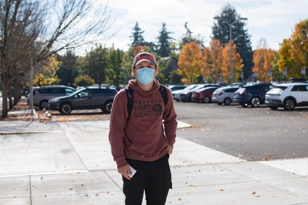 Finn Hoefer stands masked outside the new Oregon State Health Center on campus on Oct 17, 2022. 

