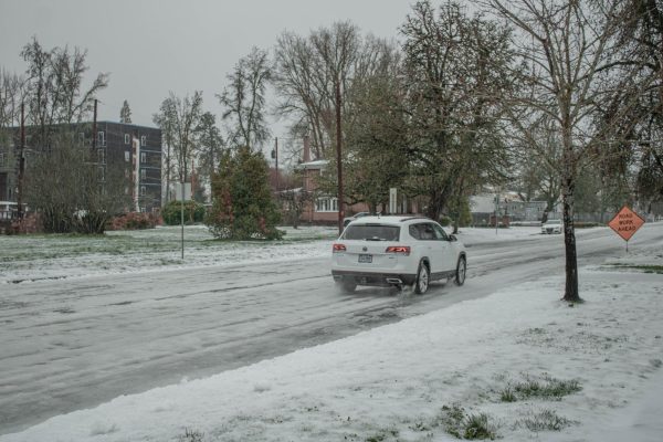 A car drives on a snow covered road in Corvallis on Jan. 16th. Icicles hang off the car due to the
freezing temperatures.