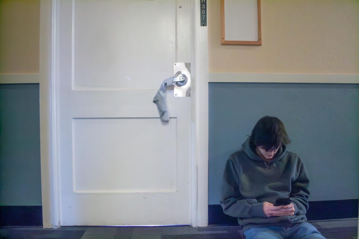 Samuel Keeps (he/him) waits outside his dorm room in Sackett Hall on Nov. 28, 2023