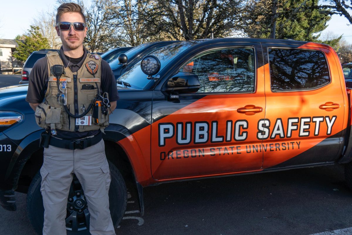 Nicholas+Herman%2C+an+Oregon+State+alumni%2C+who+is+now+an+Oregon+State+Public+Safety+Officer+poses+in+front+of+a+Public+Safety+truck+parked+in+front+of+Cascade+Hall+in+Corvallis+on+Feb.+23+2024.