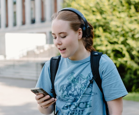 Senior Natalie Goldsmith searches for her favorite playlists outside of the Memorial Union on May 13, 2024.
