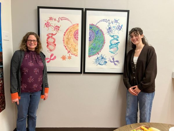 AJ Damiana (left) and Dr. Alysia Vrailas-Mortimer next to Damianas painting titled The Cell-ebration of Life, taken in the Little Gallery