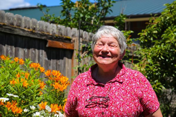 Louise Barden smiles in her garden in Corvallis on June 28. 