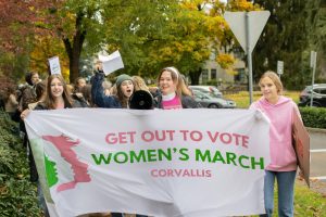 Allison Doss and other organizers of the Women’s March lead the group as they
walk through Corvallis on Nov 2.