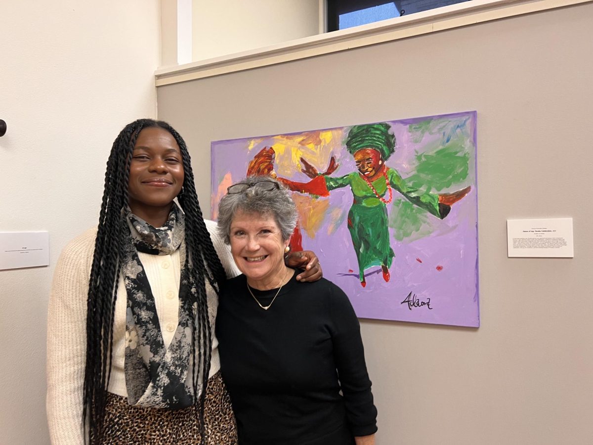 Artist and grad student, Victory Obieke (left) along with Helen Wilhelm (right) the director of the Little Gallery at the "Whispers of Home" exhibit on Nov. 5.