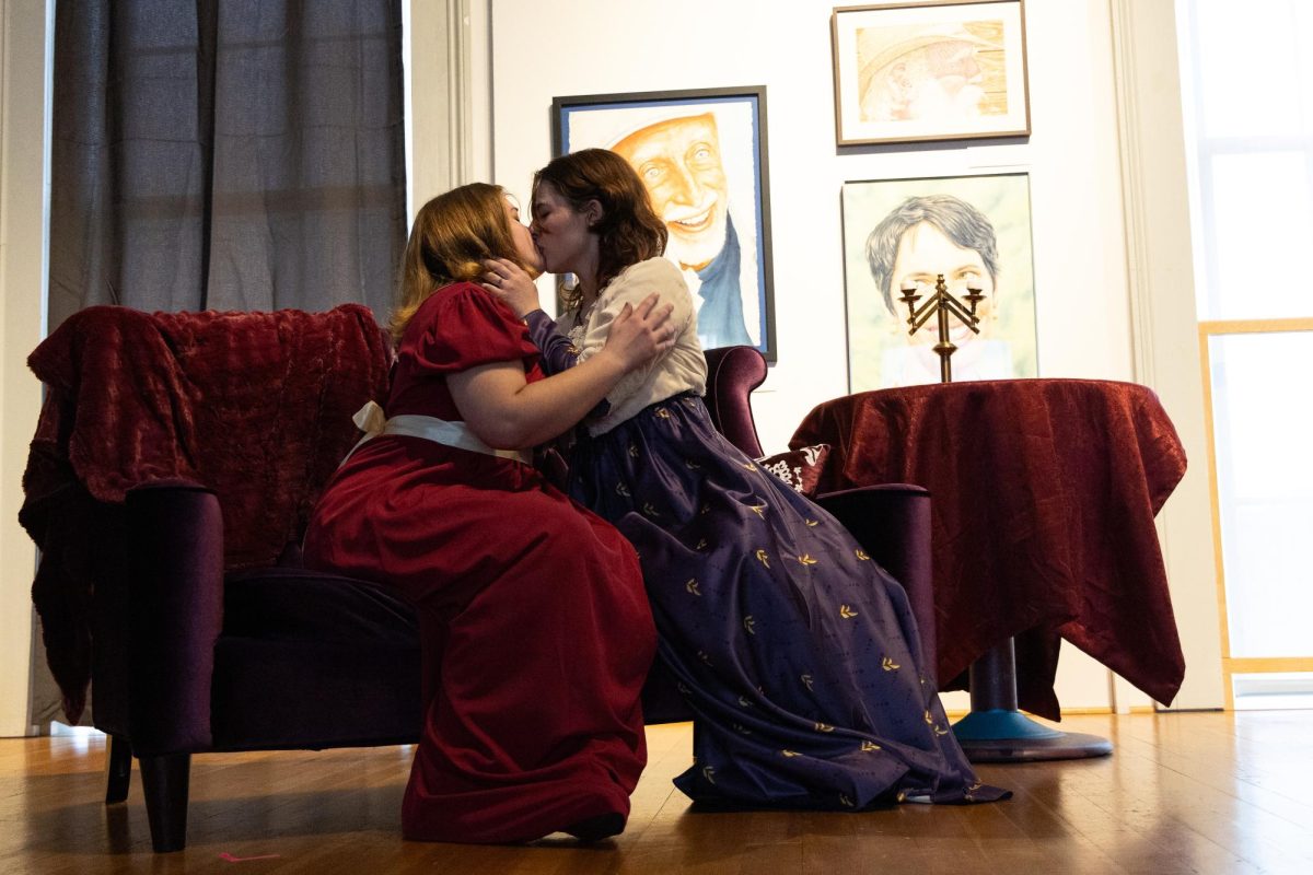 Geraldine (left, Kip McAllen) kisses Christabel (Addison Hoppe) during Violets in the Night tech rehearsal on Sunday, Feb. 9 in the Philomath Museum. Violets in the Night is a student-written and produced play that will be showing in the Philomath Museum.