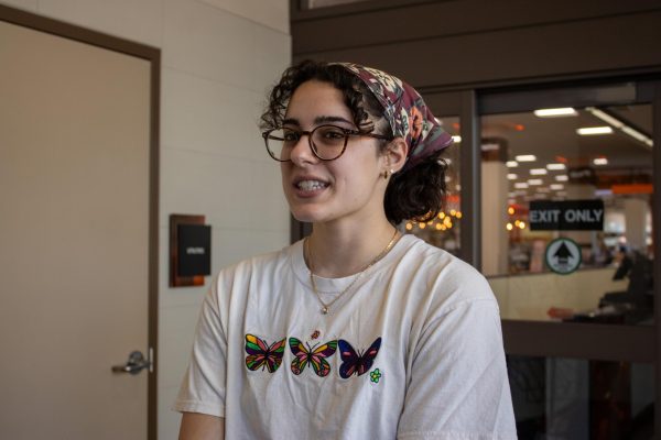 Fourth-year Kate Zaine stands outside of the beaver store on campus April 15. After getting her cap and gown, she stopped to explain how she deals with senioritis.