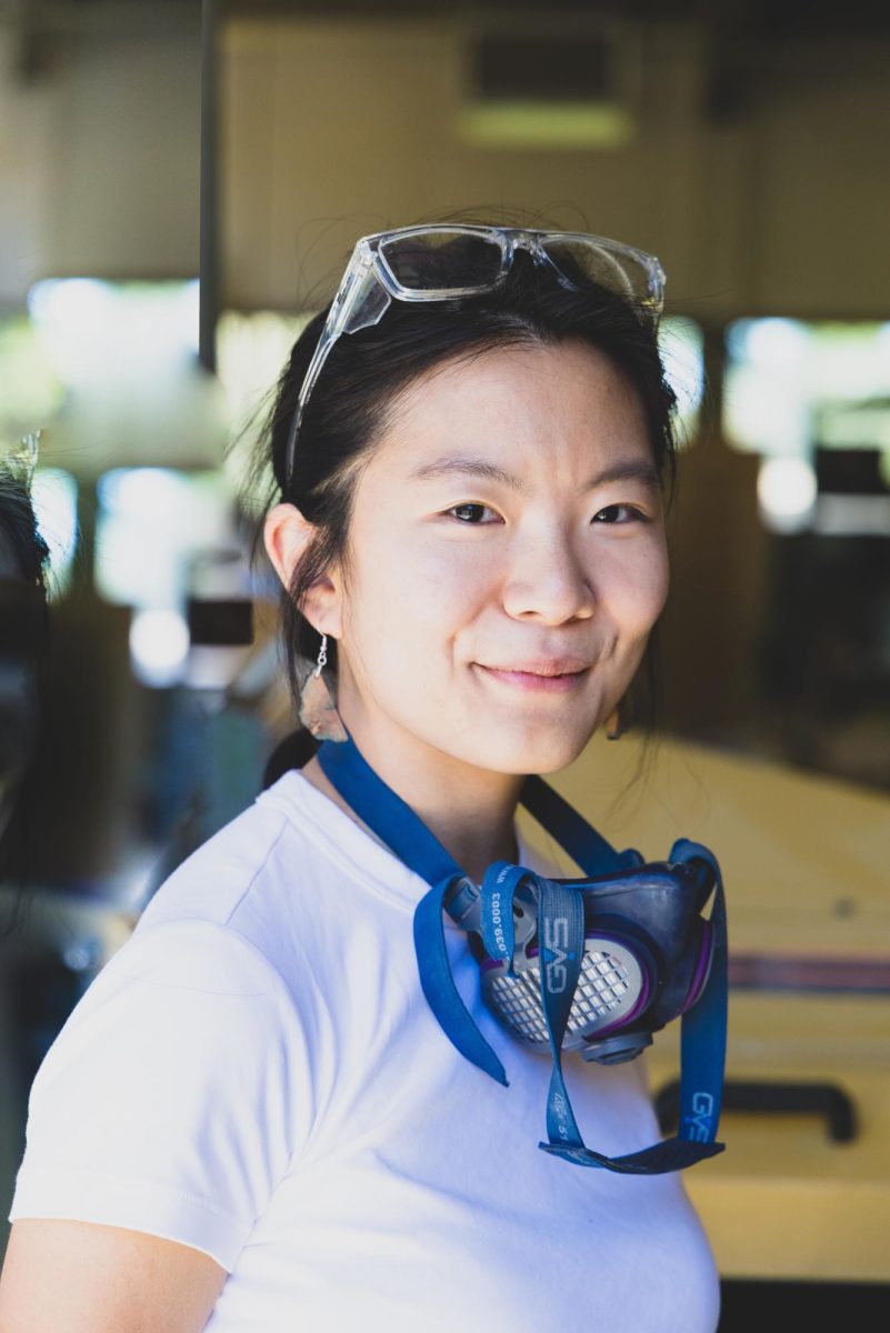 A woman with goggles hanging off her neck