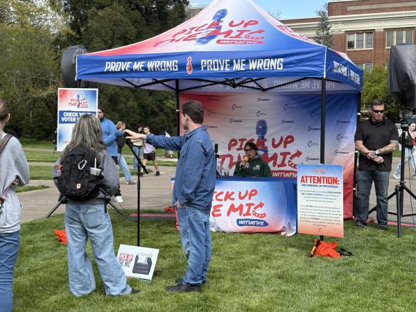 Chloe Cole, Turning Point USA speaker and advocate against gender affirming care argues with an Oregon State University student during the “Prove Me Wrong” event on the Memorial Union Quad on April 13.